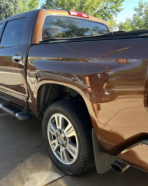 A brown Toyota Tundra, rear three-quarter