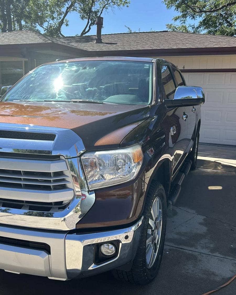 A brown Toyota Tundra from the front, chrome grille