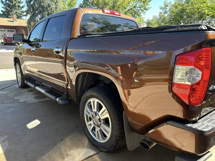 A brown Toyota Tundra, rear three-quarter