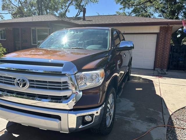 A brown Toyota Tundra from the front, chrome grille