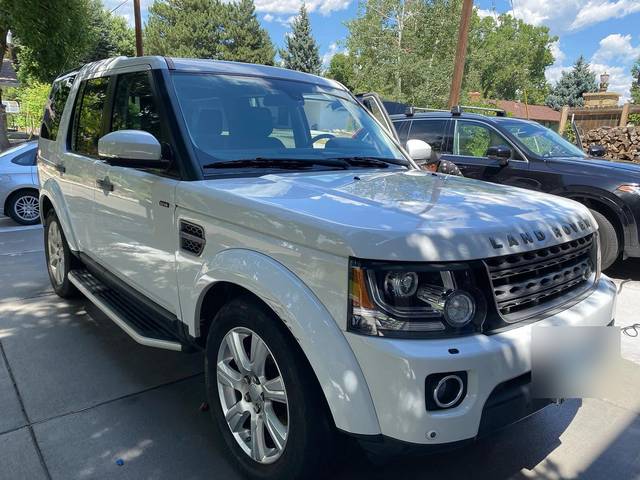 A white Land Rover from the front