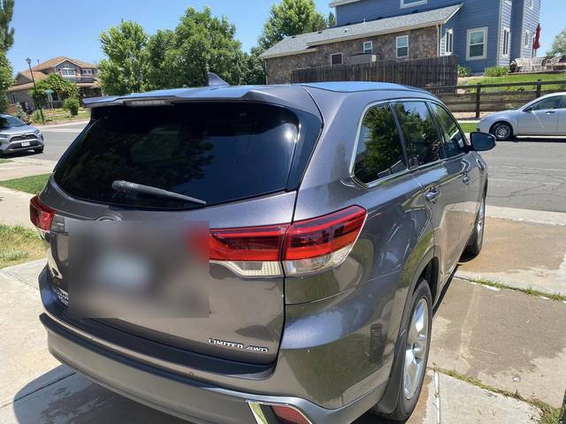 A gray Toyota Highlander, rear three-quarter
