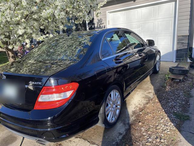 A black Mercedes sedan, rear three-quarter