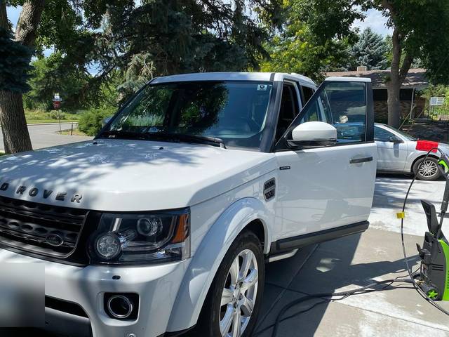 A white Land Rover, front three-quarter