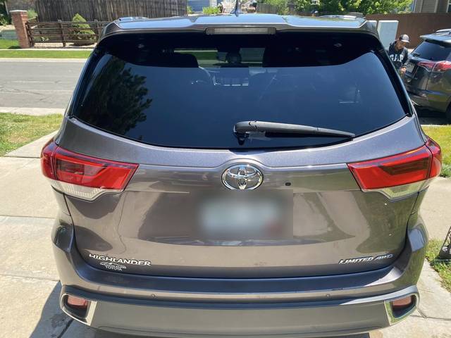 A gray Toyota Highlander from the rear
